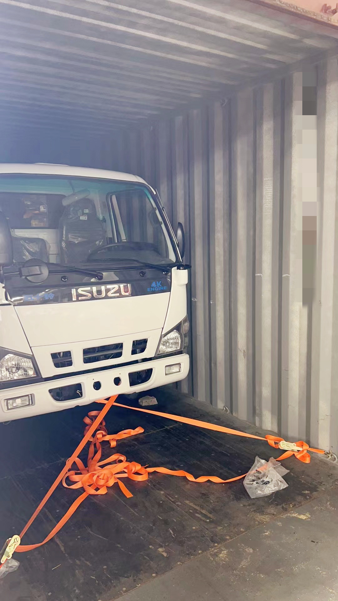 How do we load the isuzu crane into the container?